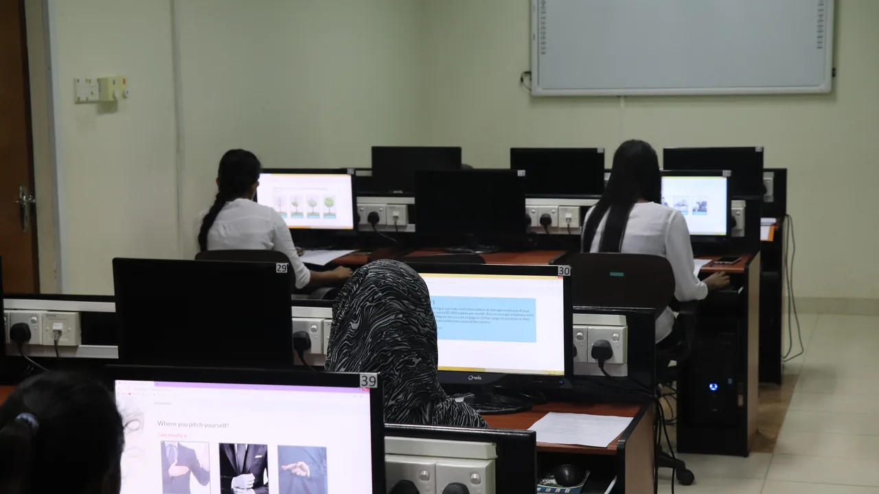 Estudantes trabalhando em computadores durante uma atividade escolar de investigação